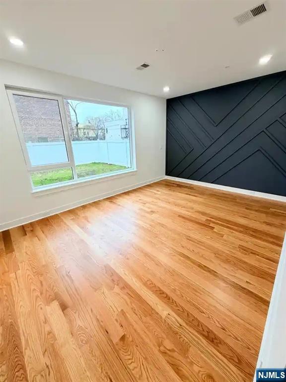 39 South 7th Street, Unit 2 3 Newark, NJ 07107 - Photo 8 of 13 a view of an empty room with wooden floor and a window