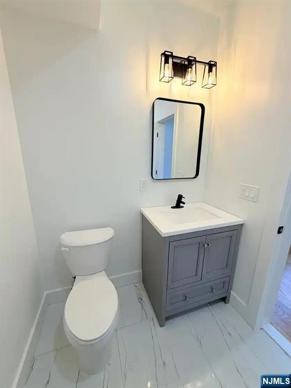 39 South 7th Street, Unit 2 3 Newark, NJ 07107 - Photo 10 of 13 a bathroom with a toilet a sink and mirror