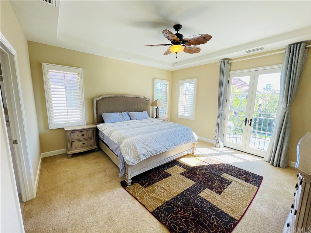 71 Thornapple Irvine, CA 92620 - Photo 1 of 18 a bedroom with a bed a chandelier and a view of balcony