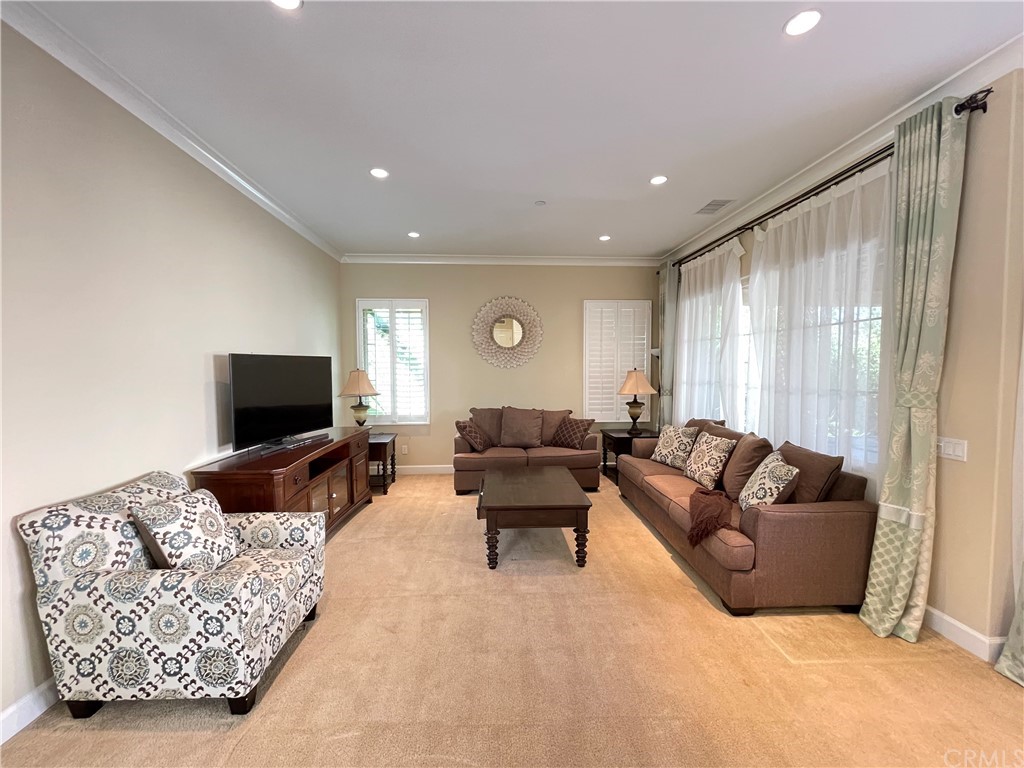 71 Thornapple Irvine, CA 92620 - Photo 11 of 18 a living room with furniture and a flat screen tv