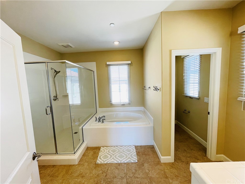 71 Thornapple Irvine, CA 92620 - Photo 2 of 18 a bathroom with a tub a sink and a mirror