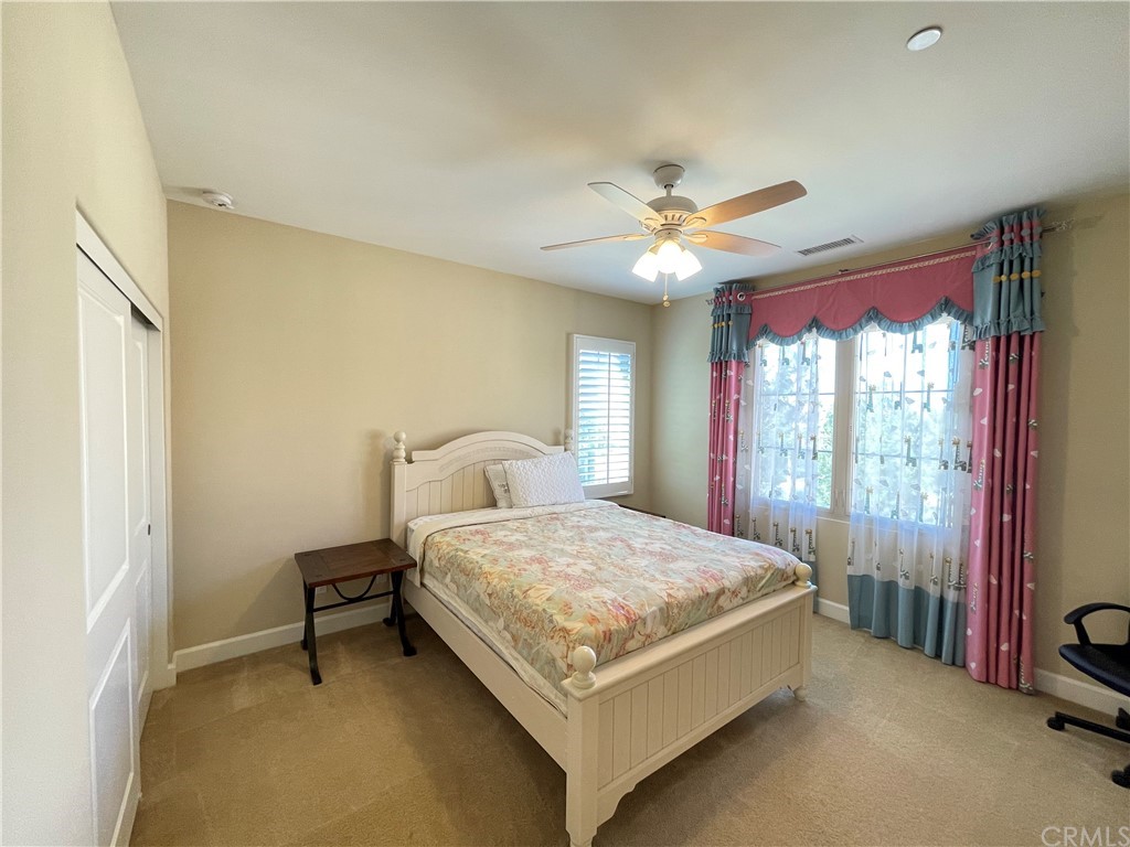 71 Thornapple Irvine, CA 92620 - Photo 4 of 18 a bedroom with a bed and a ceiling fan