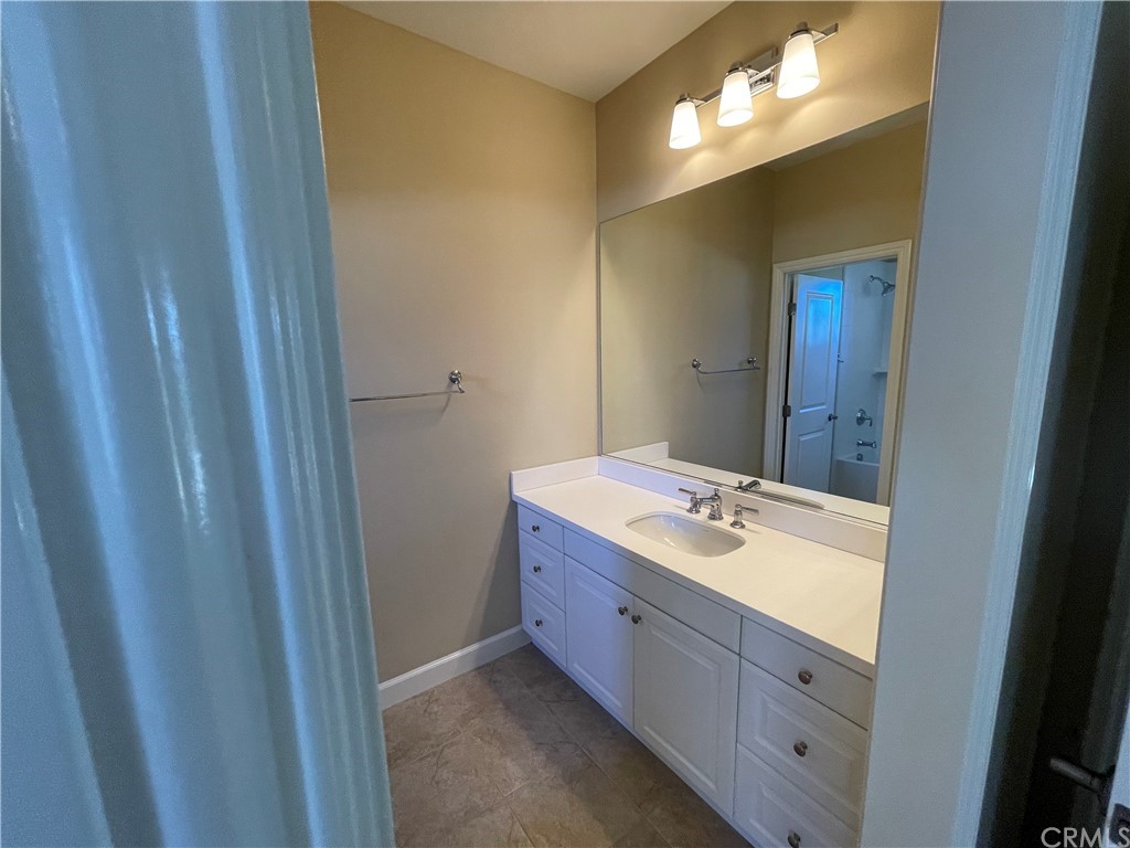 71 Thornapple Irvine, CA 92620 - Photo 5 of 18 a bathroom with a double vanity sink and a mirror
