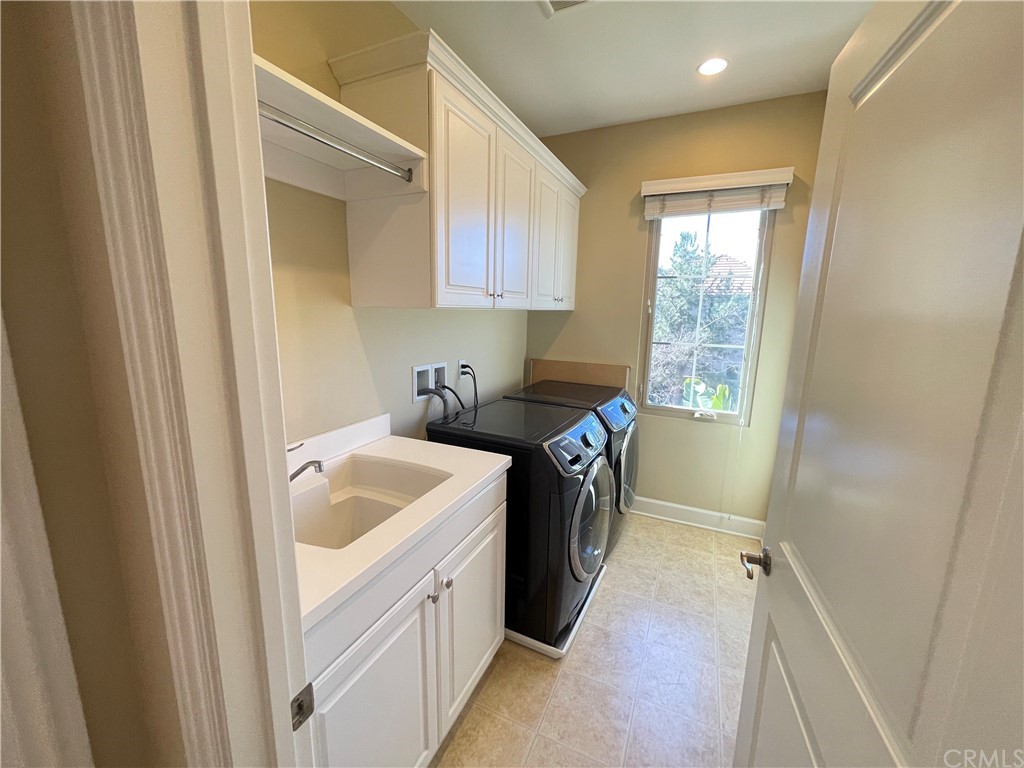 71 Thornapple Irvine, CA 92620 - Photo 7 of 18 a utility room with sink dryer and washer