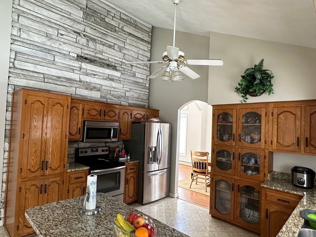 5 Telo Road Windham, NH 03087 - Photo 8 of 23 a kitchen with stainless steel appliances granite countertop a refrigerator a stove top oven a sink dishwasher and wooden floor