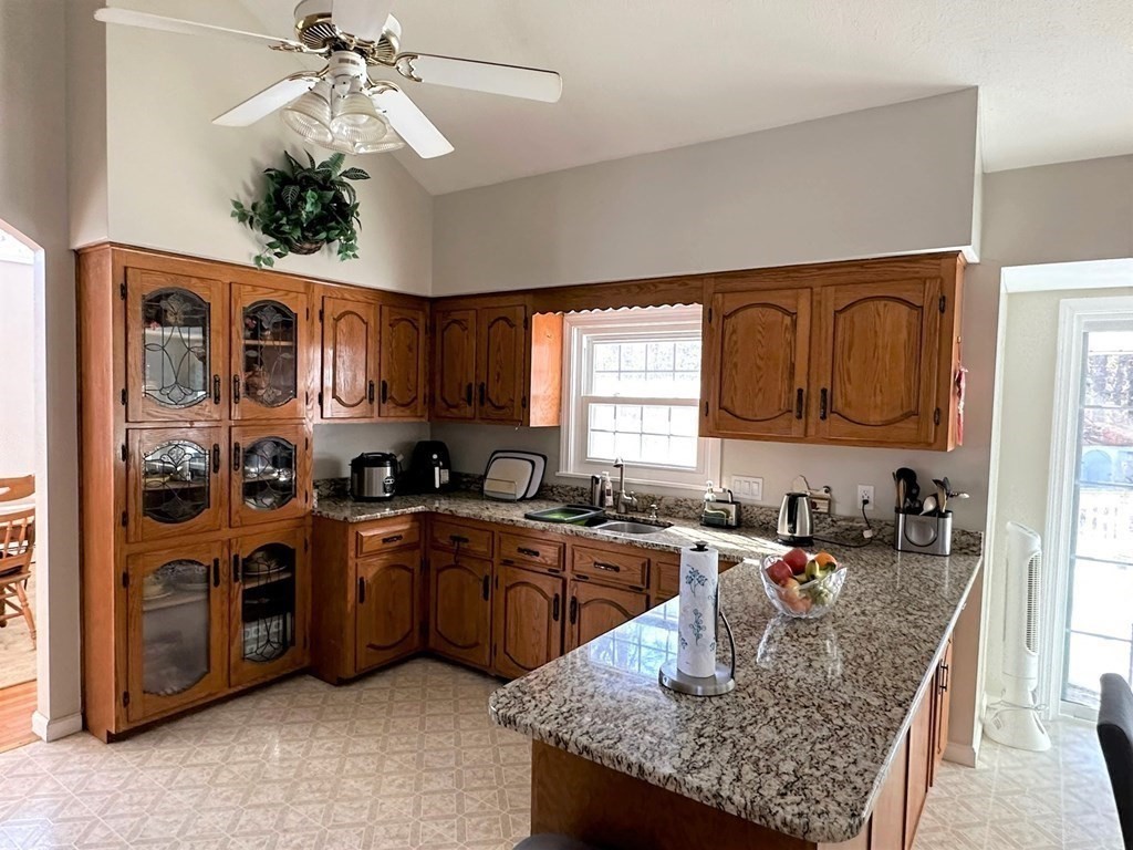 5 Telo Road Windham, NH 03087 - Photo 9 of 23 a kitchen with stainless steel appliances granite countertop a sink dishwasher stove and cabinets with wooden floor