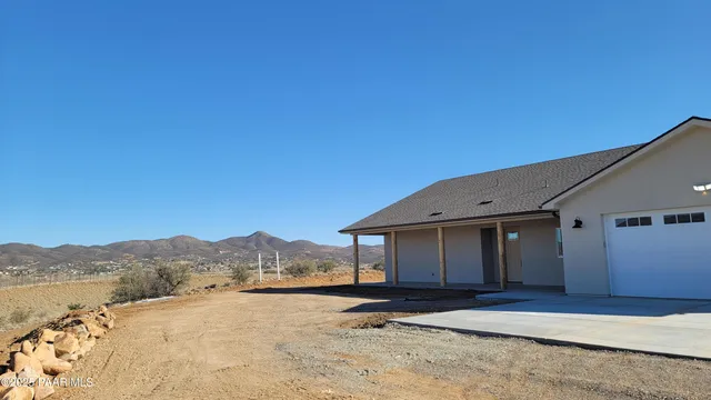 a view of a house with a snow in the background
