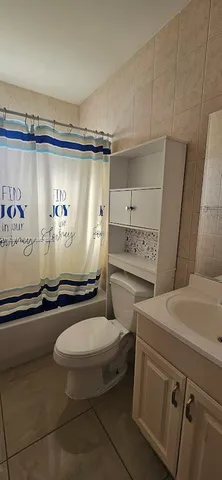 a bathroom with a sink a toilet and a shower