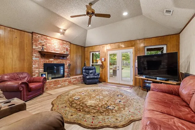 a living room with furniture a flat screen tv and a fireplace