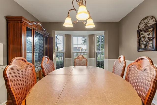 a view of a dining room with furniture and chandelier