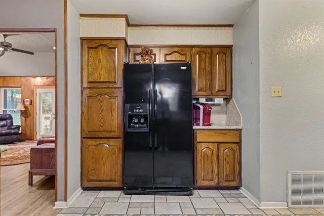 a kitchen with a refrigerator and cabinets