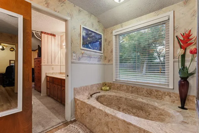 a bath tub sitting in a bathroom next to a window