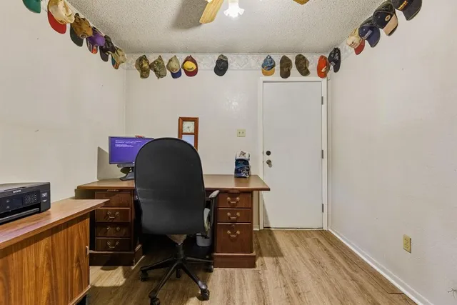 a view of a workspace with furniture and wooden floor