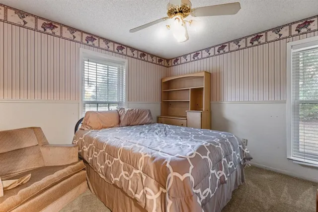 a bedroom with a bed and a chandelier