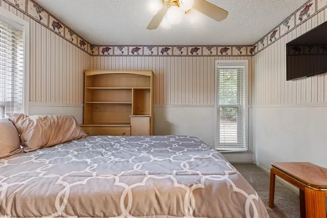 a bedroom with a bed and a television