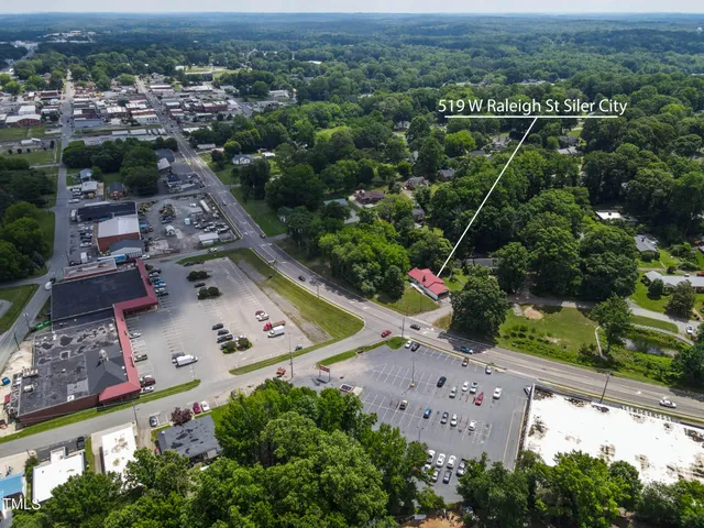 an aerial view of a house with a garden and swimming pool