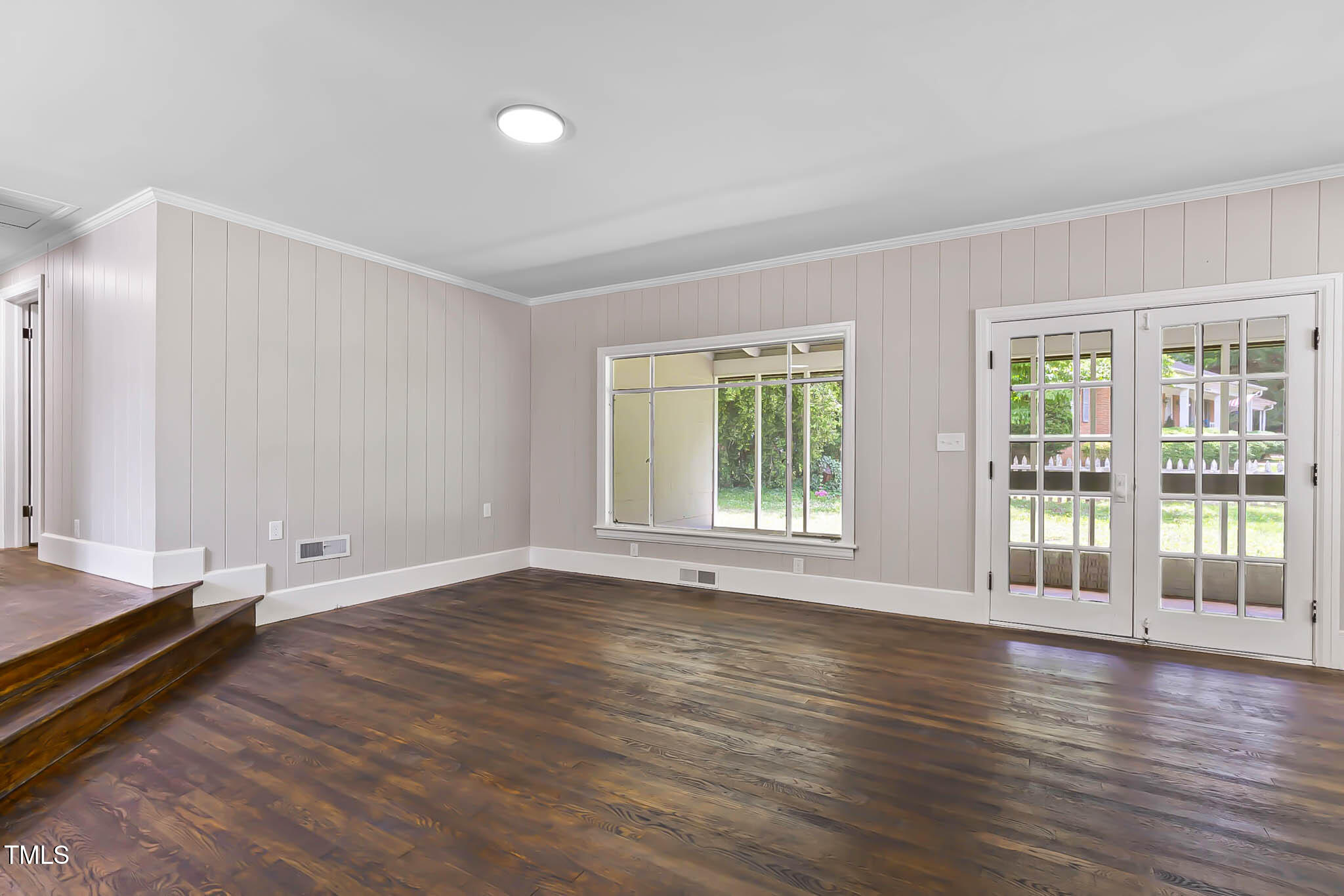 519 West Raleigh Street Siler City, NC 27344 - Photo 25 of 47 a view of an empty room with wooden floor and a window