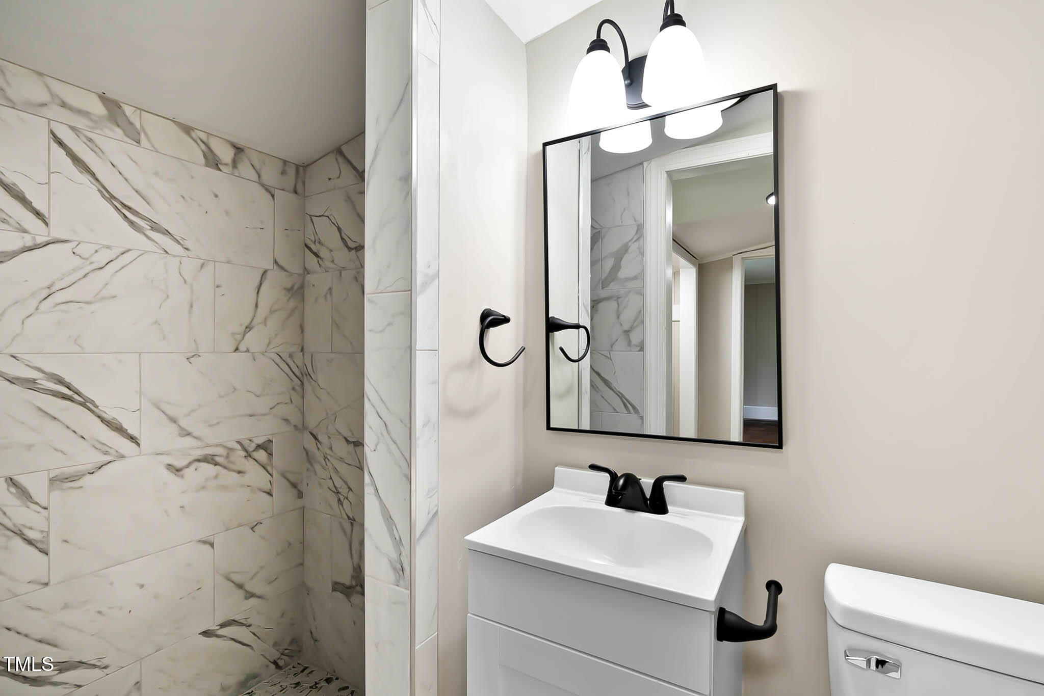 519 West Raleigh Street Siler City, NC 27344 - Photo 34 of 47 a bathroom with a sink and a mirror