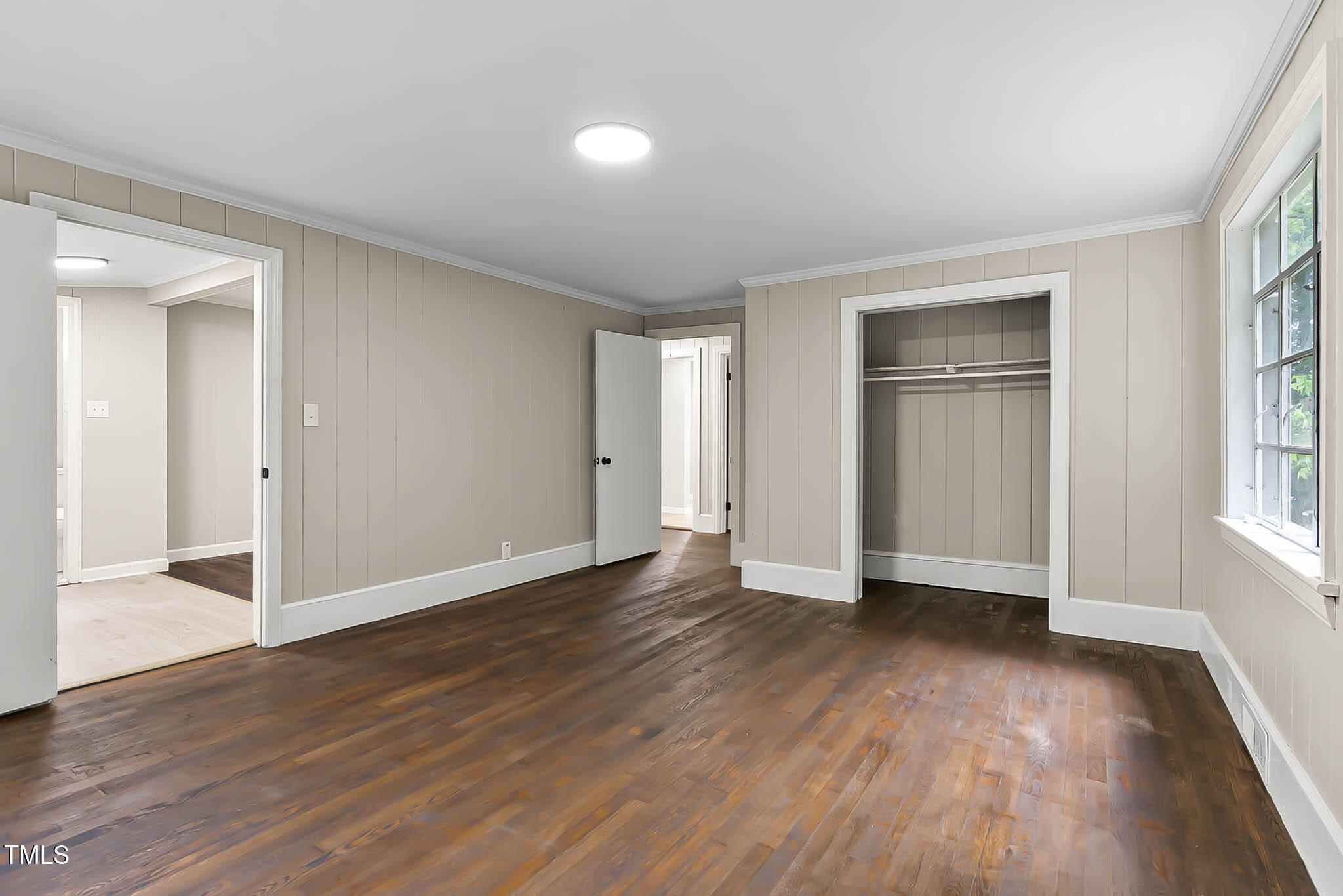 519 West Raleigh Street Siler City, NC 27344 - Photo 37 of 47 an empty room with wooden floor & windows closet and windows