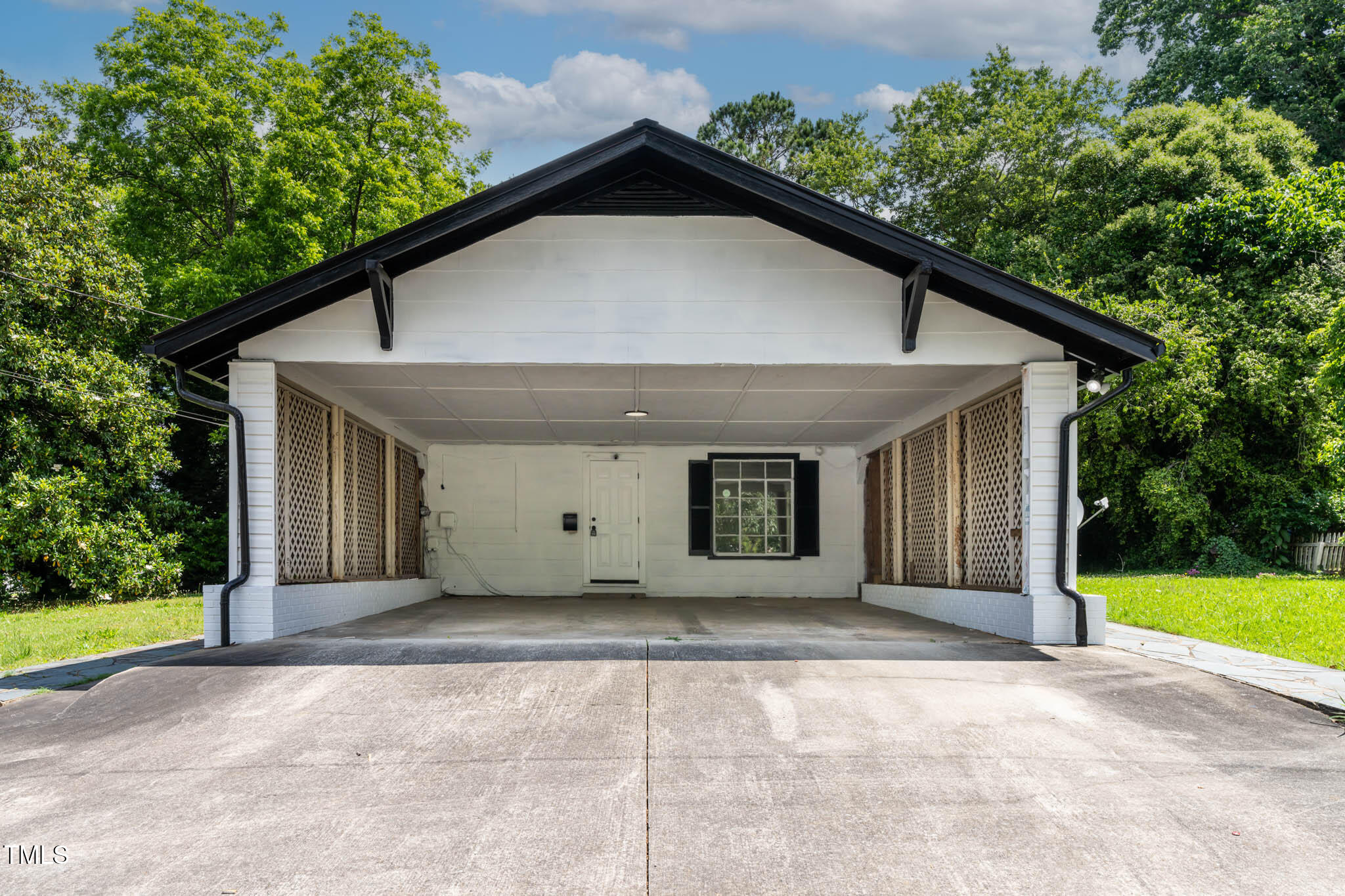 519 West Raleigh Street Siler City, NC 27344 - Photo 6 of 47 a view of a house with a yard and potted plants