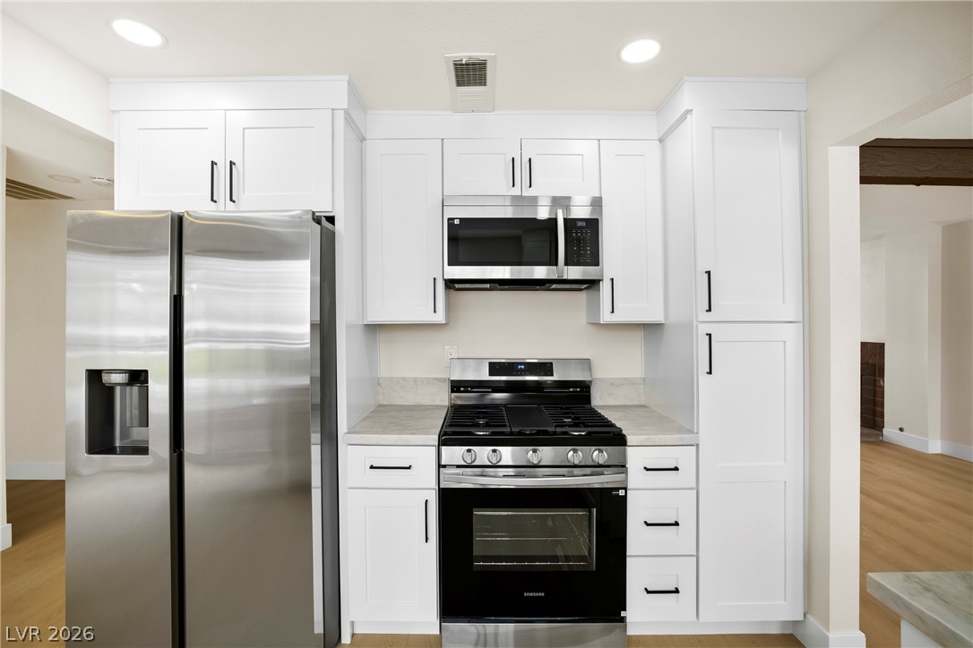 2411 Doherty Way Henderson, NV 89014 - Photo 9 of 34 A well-appointed kitchen features stainless steel appliances and ample cabinetry.