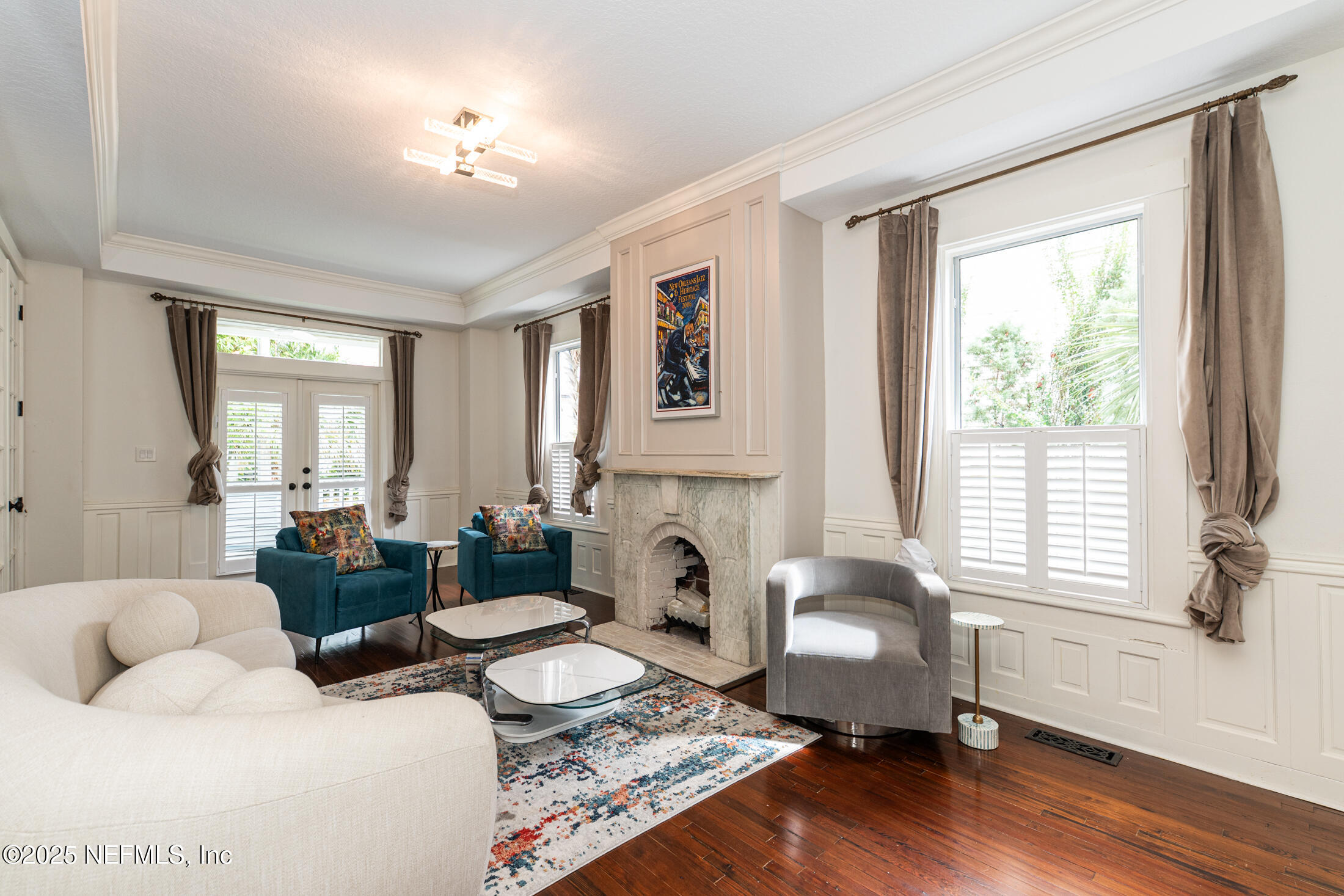 56 Water Street St. Augustine, FL 32084 - Photo 14 of 61 a living room with furniture two window and a fireplace