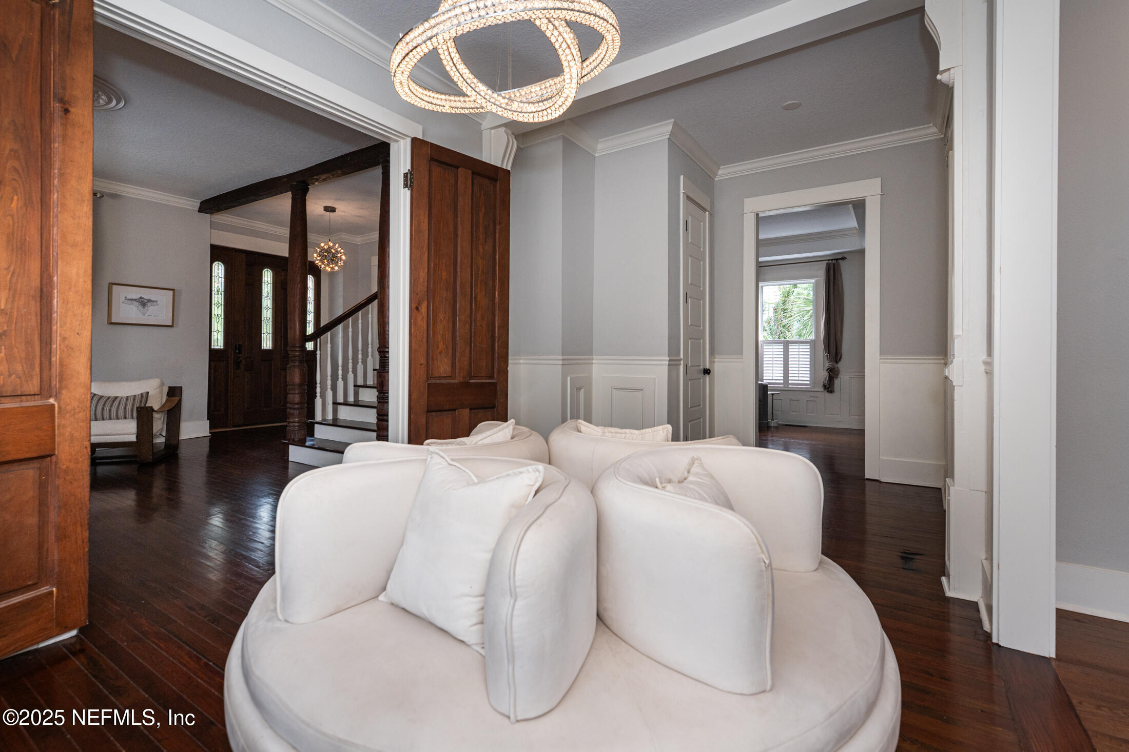 56 Water Street St. Augustine, FL 32084 - Photo 19 of 61 a bedroom with a bed and a chandelier