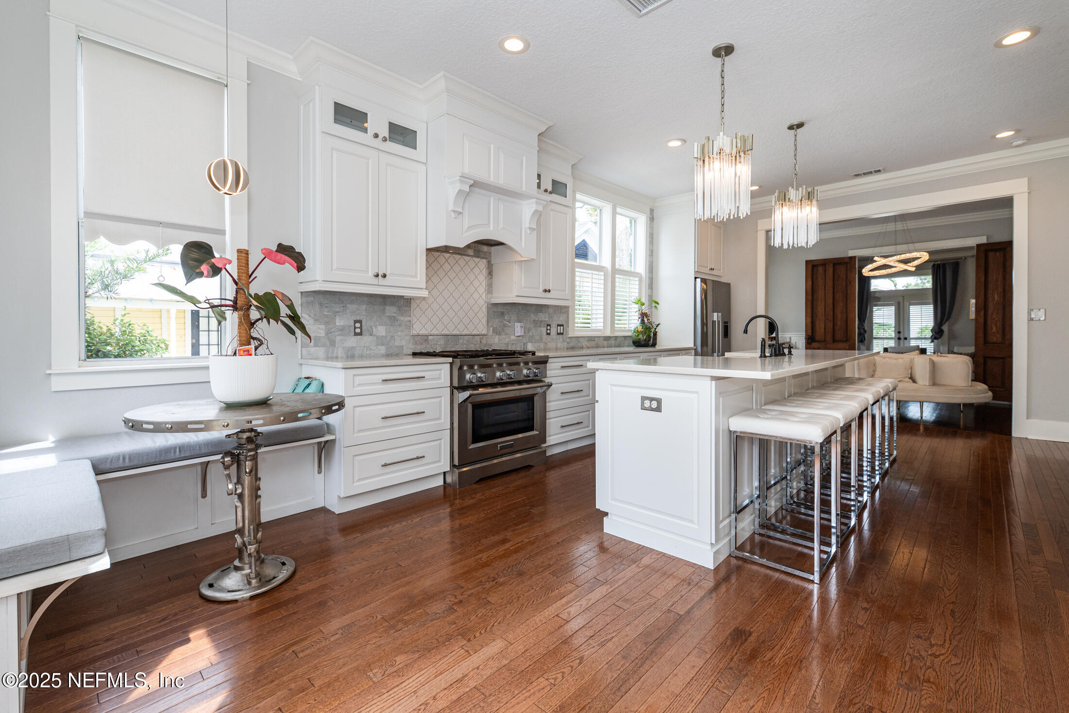 56 Water Street St. Augustine, FL 32084 - Photo 21 of 61 a kitchen with stainless steel appliances a dining table chairs stove and cabinets