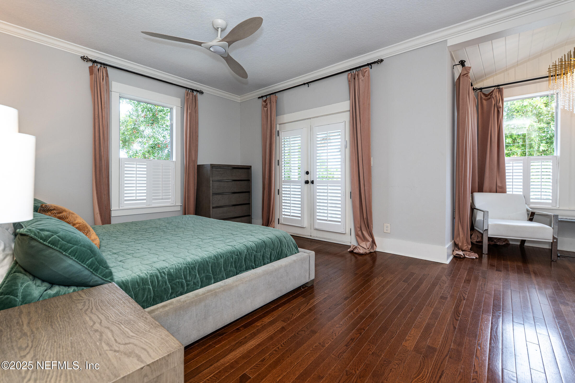 56 Water Street St. Augustine, FL 32084 - Photo 35 of 61 a bedroom with a bed and wooden floor