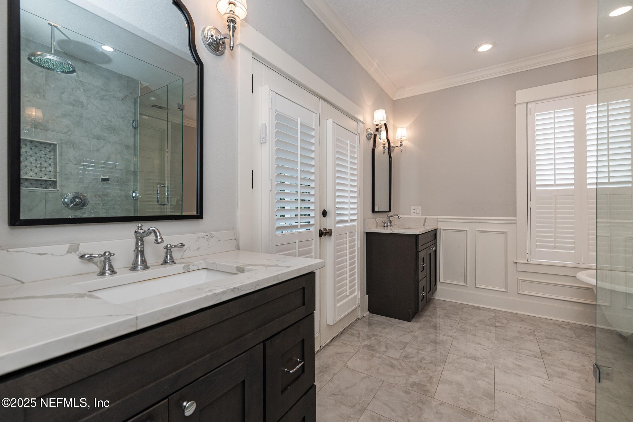 56 Water Street St. Augustine, FL 32084 - Photo 38 of 61 a bathroom with a double vanity sink a toilet and a mirror