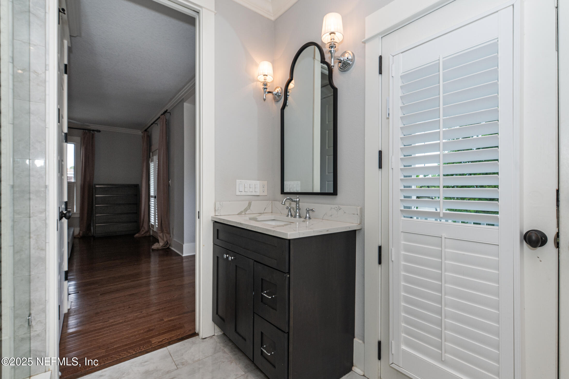 56 Water Street St. Augustine, FL 32084 - Photo 41 of 61 a bathroom with a sink and a mirror