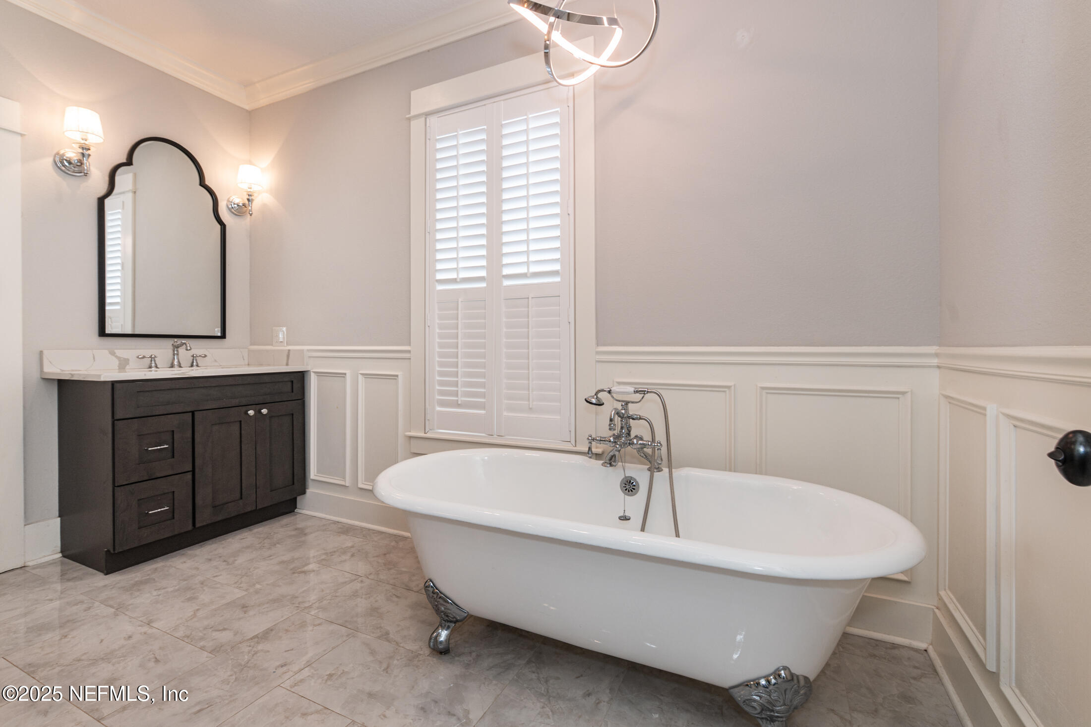 56 Water Street St. Augustine, FL 32084 - Photo 42 of 61 a spacious bathroom with a tub sink and mirror
