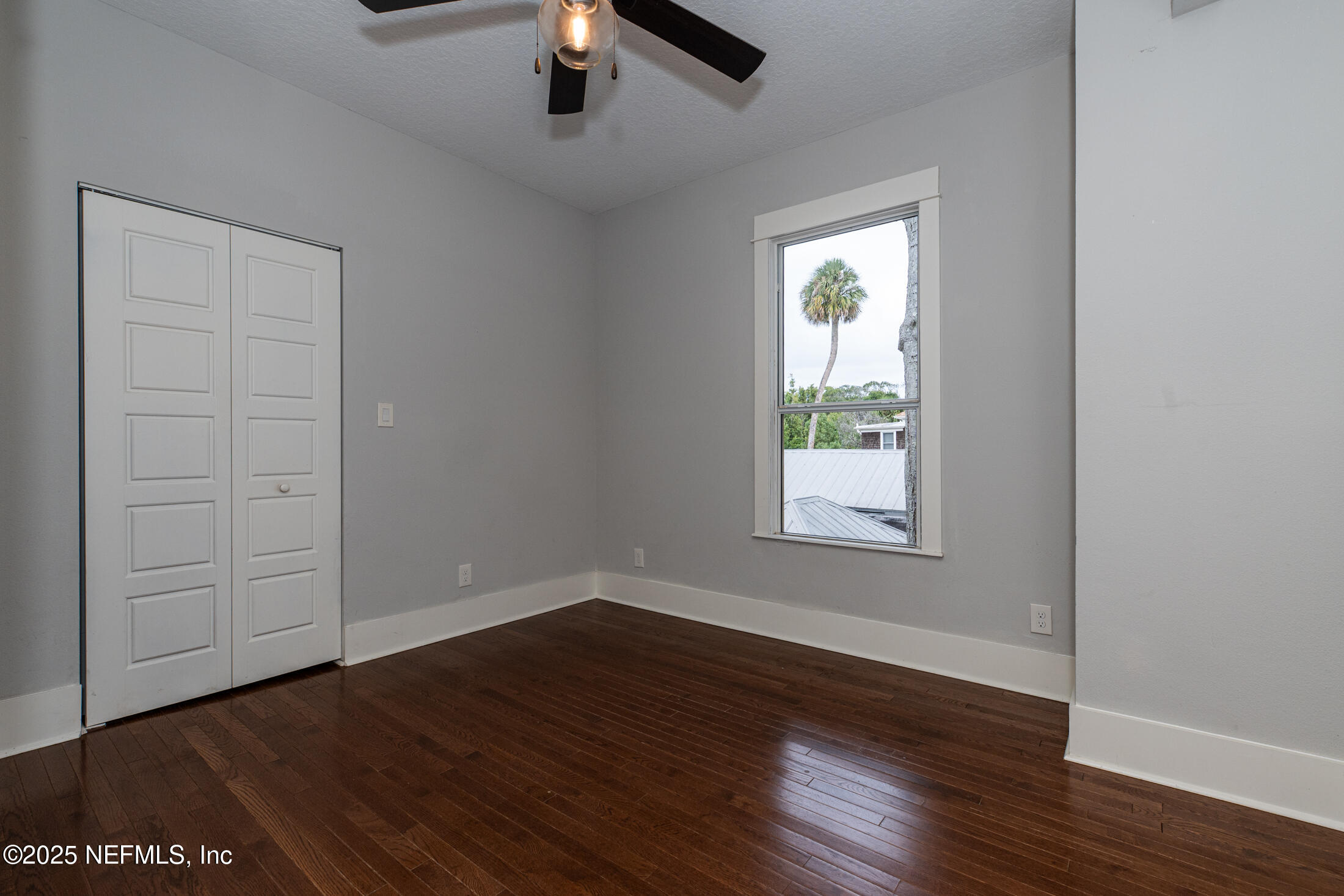 56 Water Street St. Augustine, FL 32084 - Photo 46 of 61 an empty room with wooden floor cabinet and windows