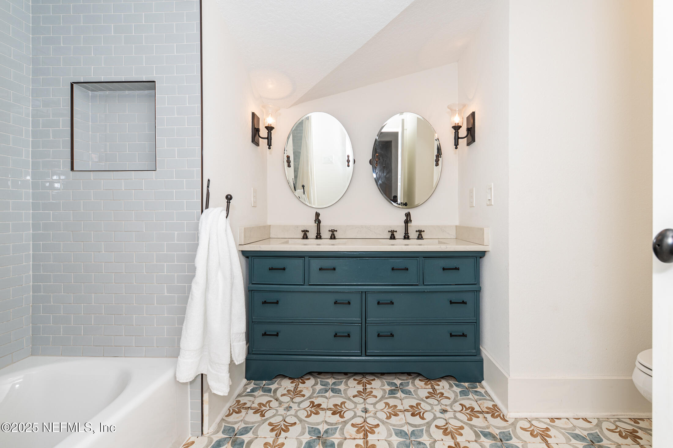56 Water Street St. Augustine, FL 32084 - Photo 48 of 61 a bathroom with a tub sink and mirror