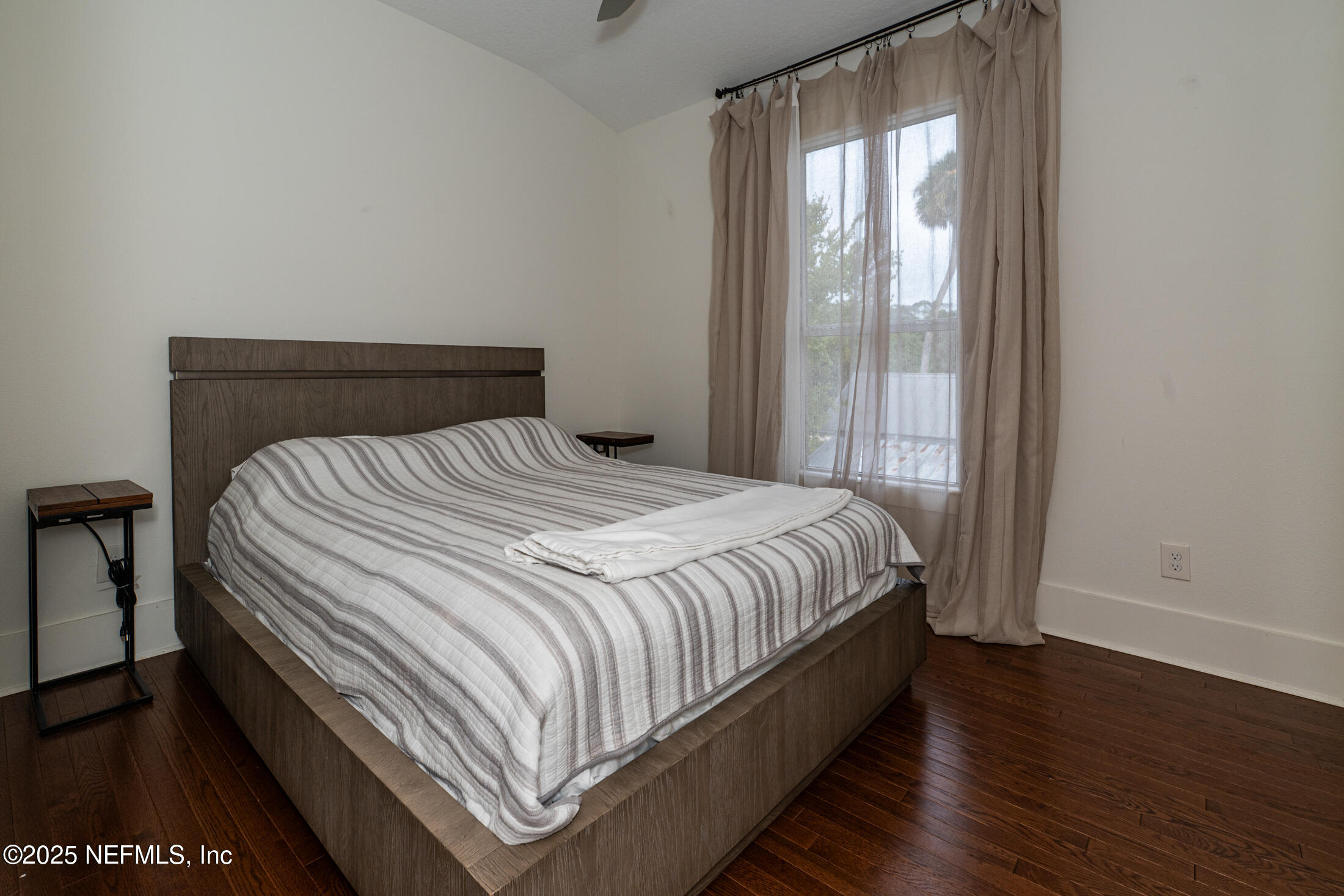 56 Water Street St. Augustine, FL 32084 - Photo 49 of 61 a bed sitting in a bedroom next to a window