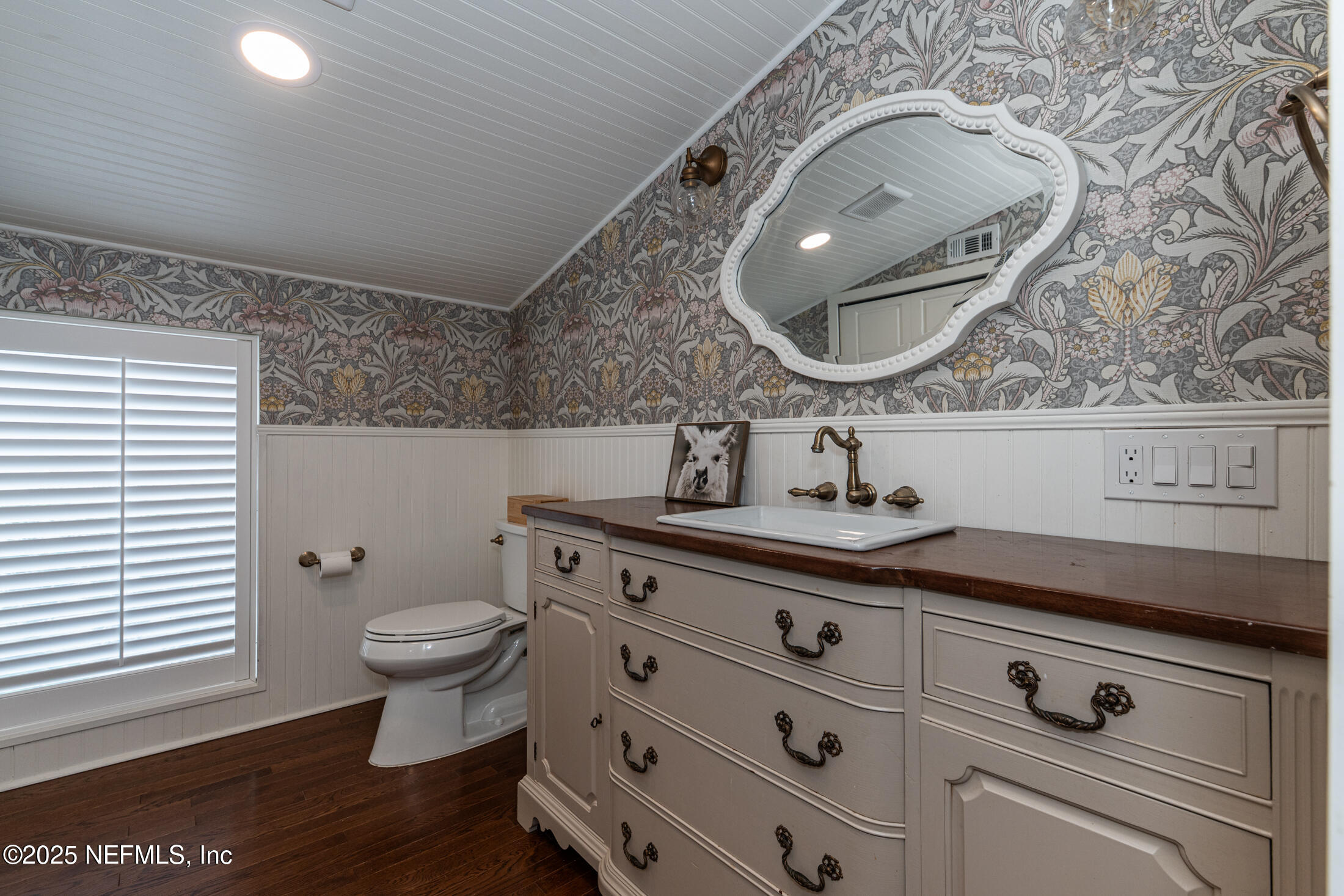 56 Water Street St. Augustine, FL 32084 - Photo 53 of 61 a bathroom with a toilet a sink and mirror