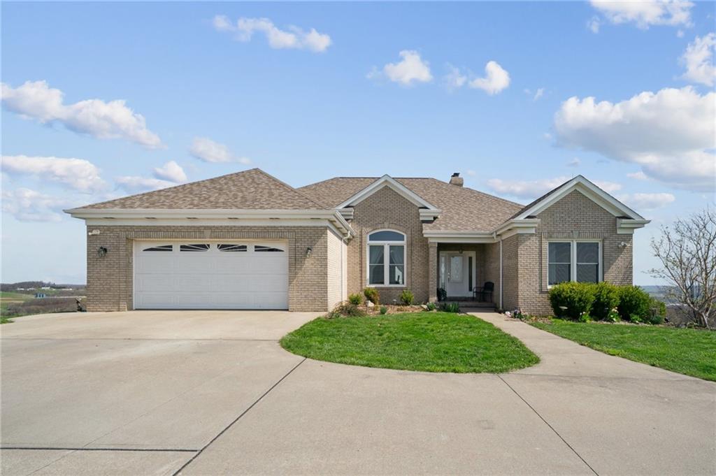 a front view of a house with a garden and yard