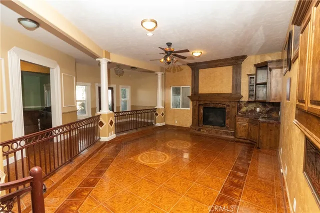 a view of a hallway with a fireplace and cabinets