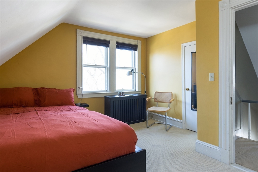 10 Howland Street Cambridge, MA 02138 - Photo 11 of 14 a bedroom with a bed and wooden floor