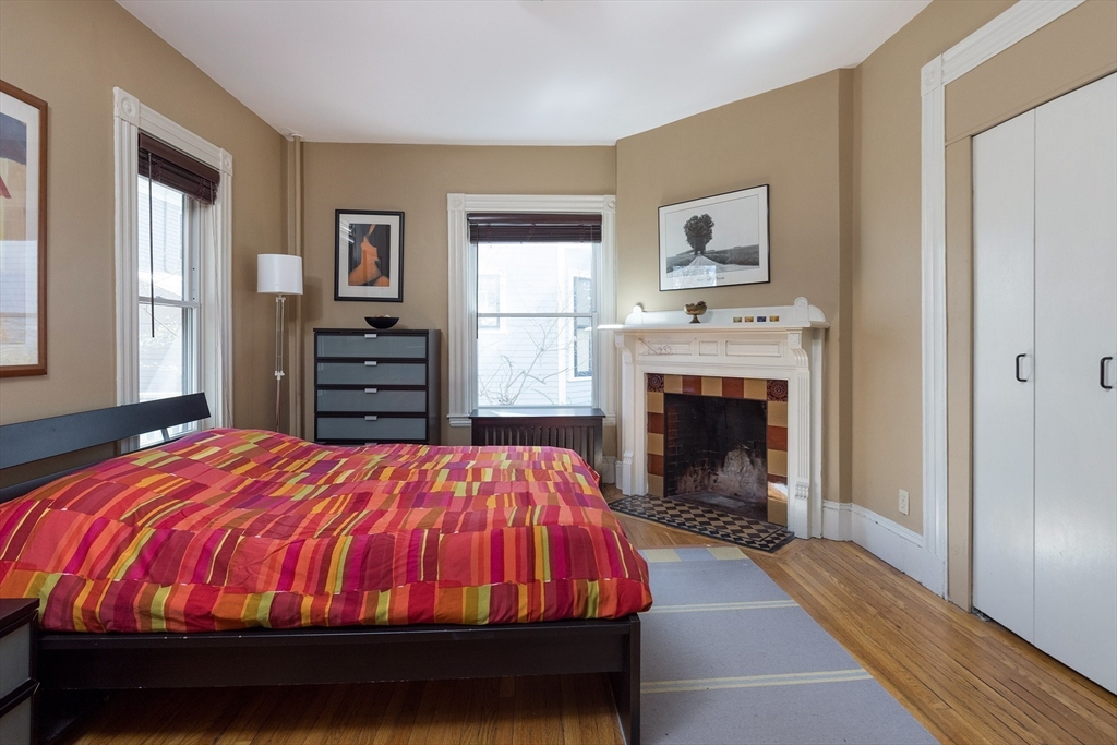 10 Howland Street Cambridge, MA 02138 - Photo 4 of 14 a bedroom with a bed and a fireplace