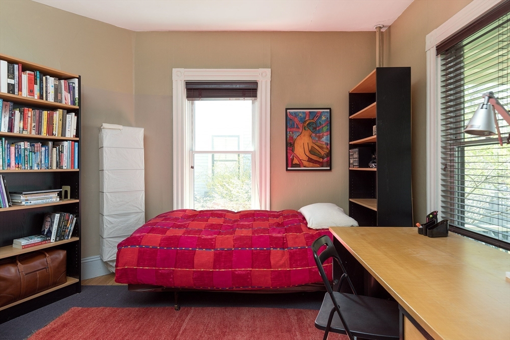 10 Howland Street Cambridge, MA 02138 - Photo 5 of 14 a bedroom with a bed and a bookshelf