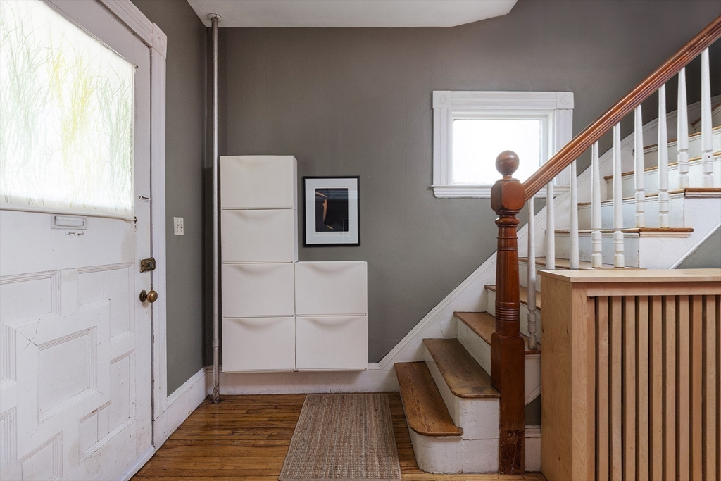 10 Howland Street Cambridge, MA 02138 - Photo 6 of 14 a view of entryway with wooden floor and stairs
