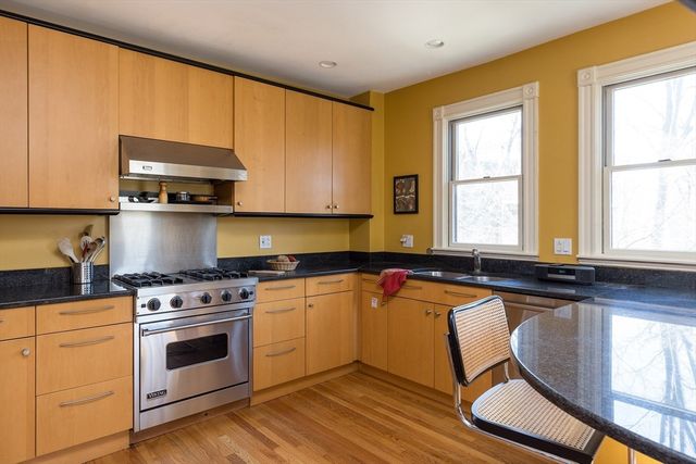 a kitchen with a stove a sink and a microwave