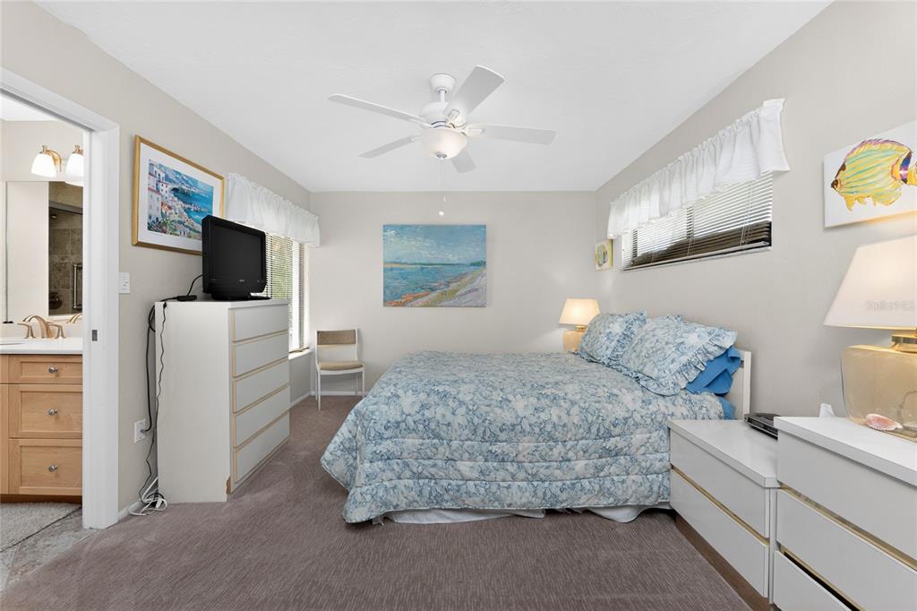2955 North Beach Road, Unit B614 Englewood, FL 34223 - Photo 24 of 67 a bedroom with a bed and a television
