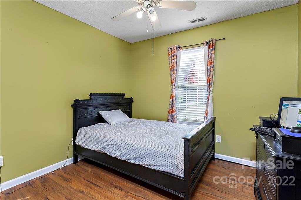 2220 Meadecroft Road Charlotte, NC 28214 - Photo 11 of 16 a bed sitting in a bedroom next to a window