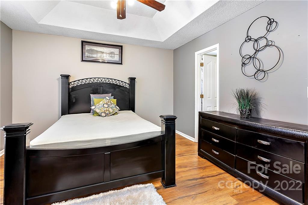 2220 Meadecroft Road Charlotte, NC 28214 - Photo 12 of 16 a bedroom with a bed and a potted plant on the dresser