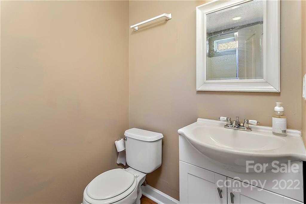 2220 Meadecroft Road Charlotte, NC 28214 - Photo 13 of 16 a bathroom with a sink a toilet and mirror