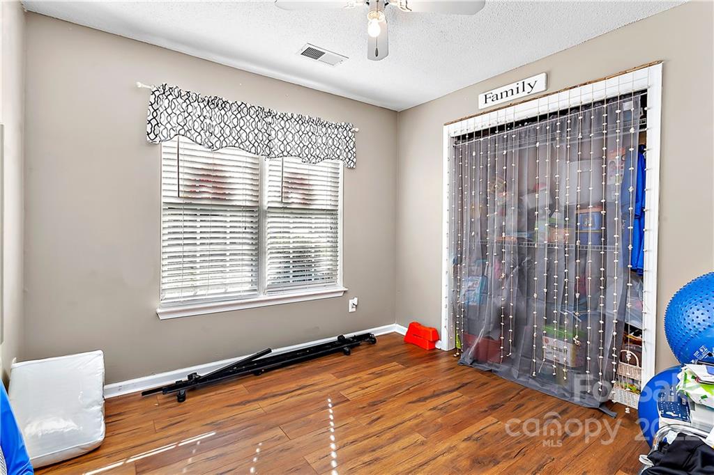 2220 Meadecroft Road Charlotte, NC 28214 - Photo 9 of 16 a bed room with a bed and a chair