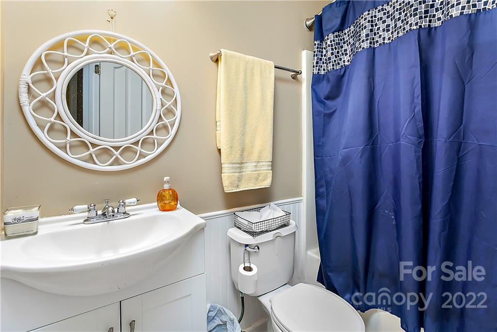 2220 Meadecroft Road Charlotte, NC 28214 - Photo 10 of 16 a bathroom with a toilet a sink and a mirror
