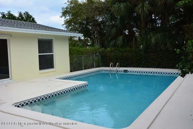 220 Puritan Road West Palm Beach, FL 33405 - Photo 2 of 10 a view of a swimming pool with a yard
